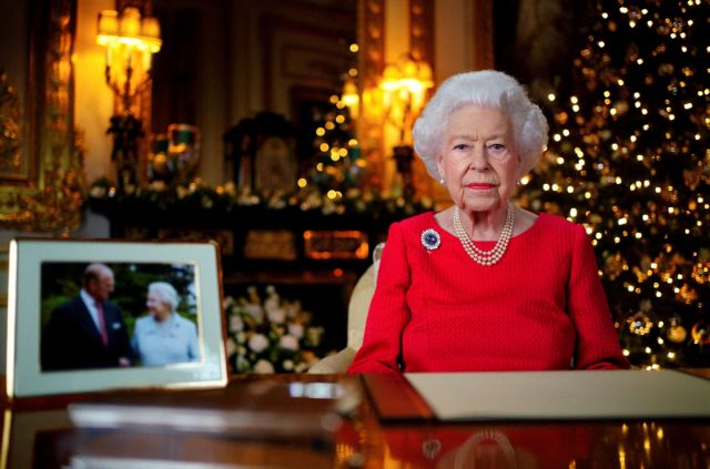 Britain's Queen Elizabeth records her annual Christmas broadcast in the White Drawing Room in Windsor Castle, next to a photograph of the queen and the Duke of Edinburgh, in Windsor, Britain, December 23, 2021. Victoria Jones/Pool via REUTERS/File Photo