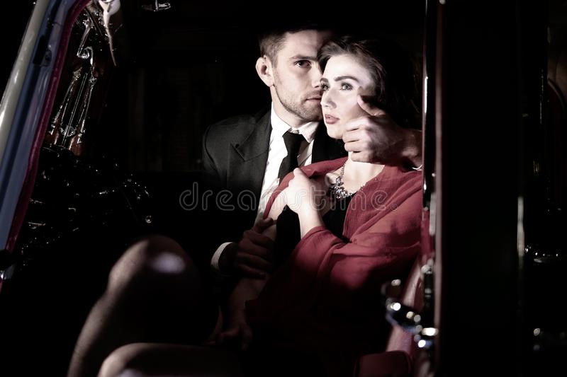good-looking-sexy-couple-handsome-man-suit-beatiful-woman-red-dress-embrace-passionately-vintage-car-men-women-touching-holding-128103678
